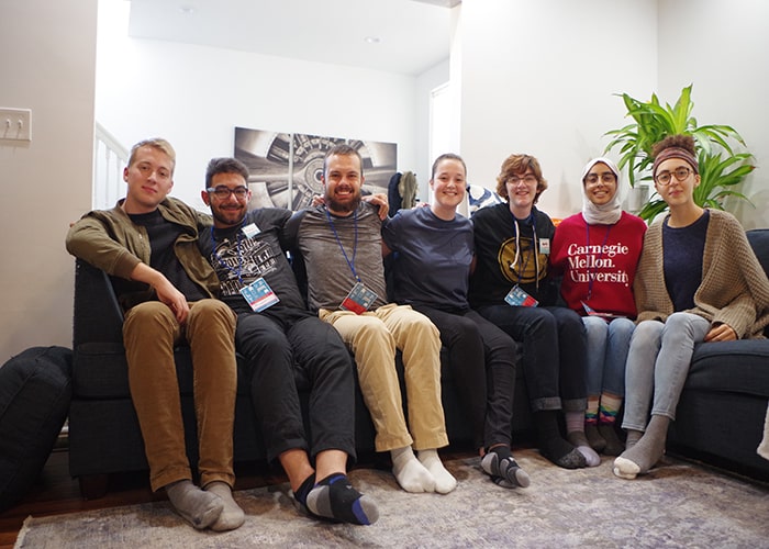 CMU students sit arm in arm at a Sit Together Project Retreat