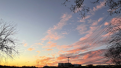 Image of the sky at sunset with a yellow horizon and pink clouds in a purple sky